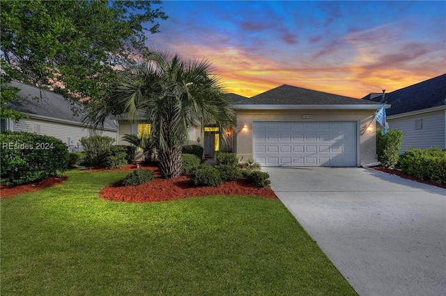 view of front of house with a garage and a lawn