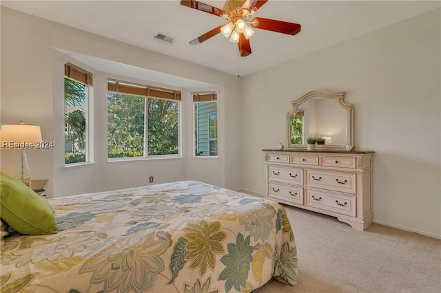 bedroom with light carpet and ceiling fan