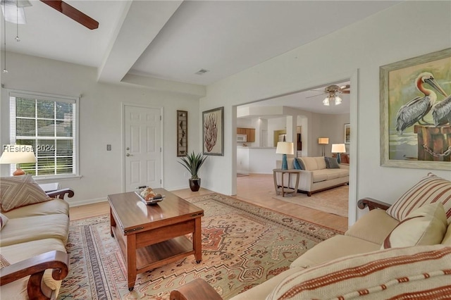 living room featuring ceiling fan and light wood-type flooring