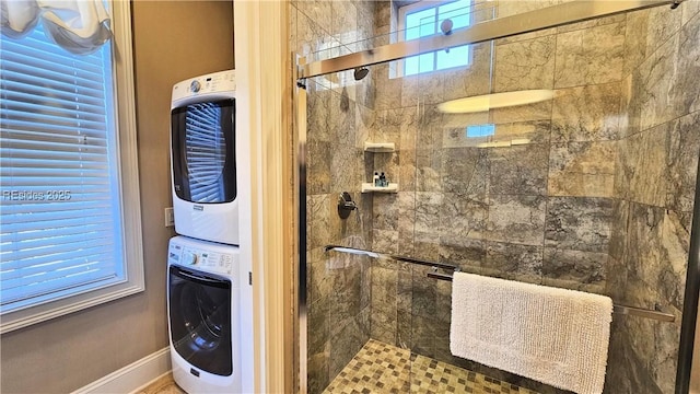 bathroom featuring walk in shower and stacked washing maching and dryer