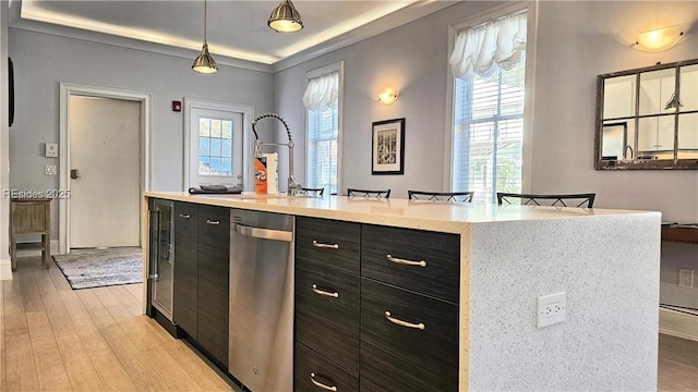 kitchen with a breakfast bar, a center island, stainless steel dishwasher, pendant lighting, and light hardwood / wood-style floors