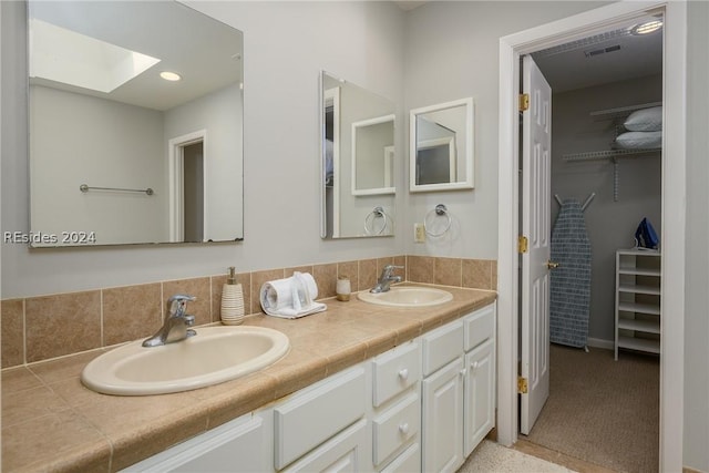 bathroom with vanity and a skylight