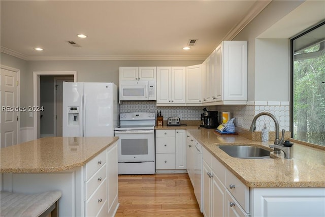 kitchen featuring white cabinetry, white appliances, light stone countertops, and sink