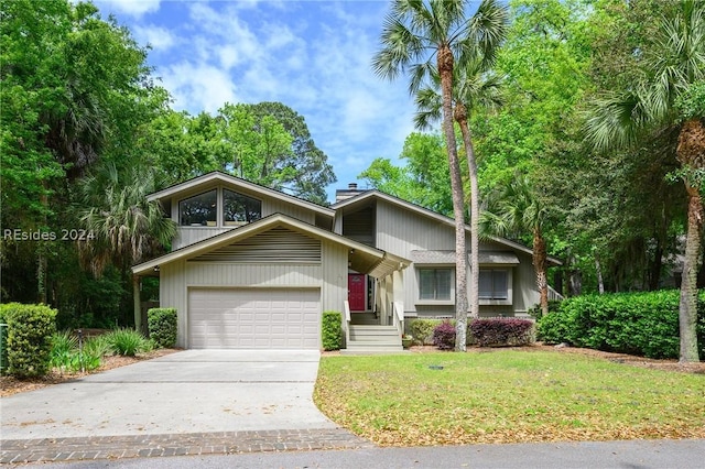 view of property with a garage and a front yard