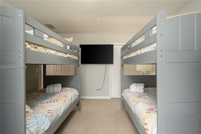 carpeted bedroom featuring a textured ceiling