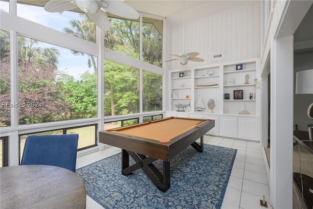 recreation room featuring light tile patterned flooring, a towering ceiling, billiards, ceiling fan, and built in shelves