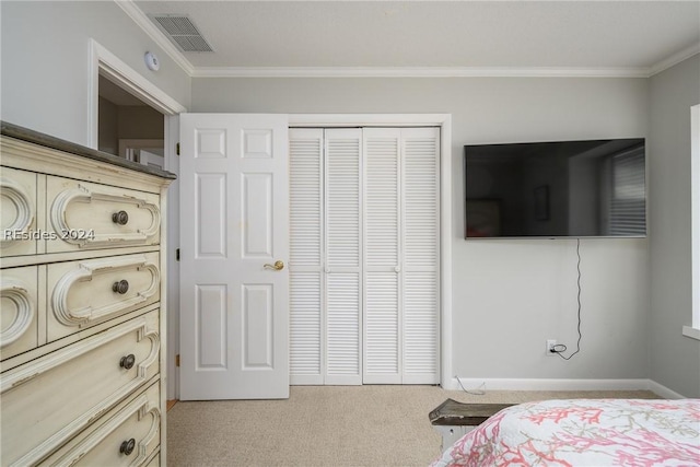 bedroom with ornamental molding, light carpet, and a closet