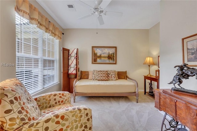 living area featuring ceiling fan and light carpet