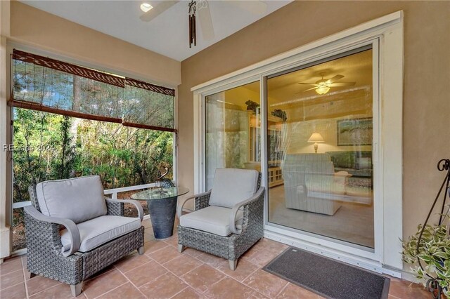 sunroom / solarium featuring ceiling fan