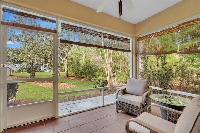 sunroom / solarium featuring ceiling fan