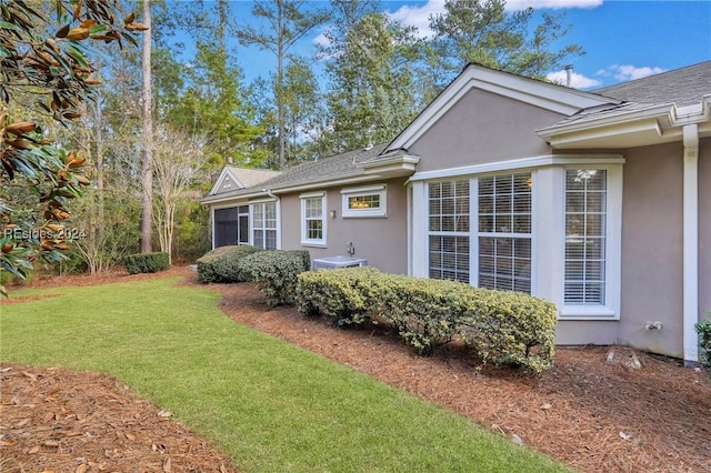 view of side of home featuring a yard