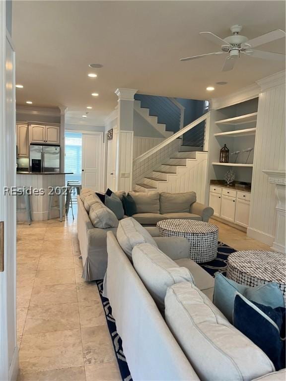 tiled living room featuring crown molding, ceiling fan, and built in features