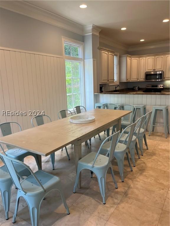 dining area featuring crown molding and light tile patterned floors