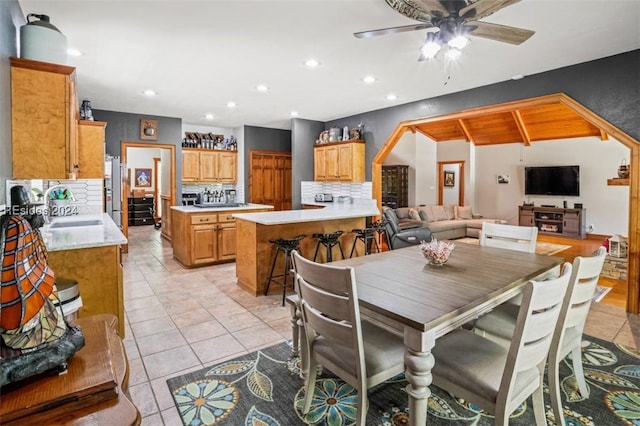 tiled dining room featuring sink and ceiling fan