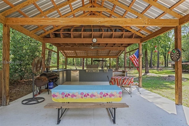 view of patio featuring a grill, a gazebo, ceiling fan, and an outdoor kitchen