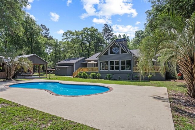 view of swimming pool with a wooden deck, a gazebo, and a lawn