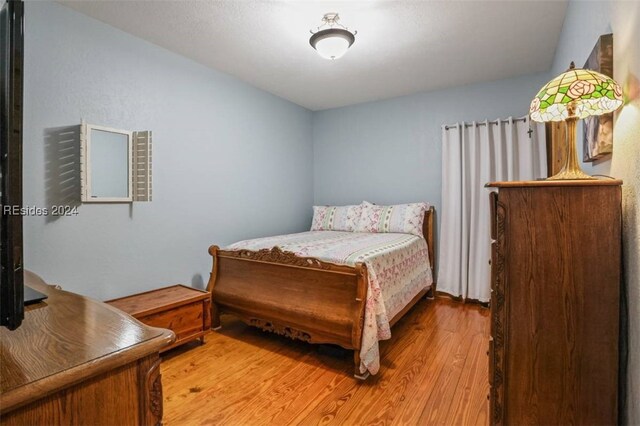 bedroom with hardwood / wood-style floors