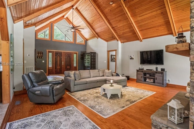 living room with ceiling fan, beam ceiling, high vaulted ceiling, and light wood-type flooring