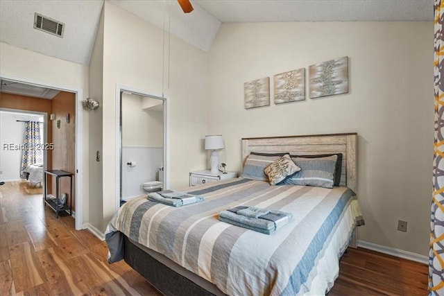 bedroom featuring ceiling fan, wood-type flooring, ensuite bathroom, and lofted ceiling