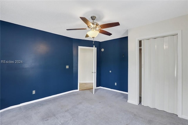 unfurnished bedroom featuring a closet, ceiling fan, and carpet flooring