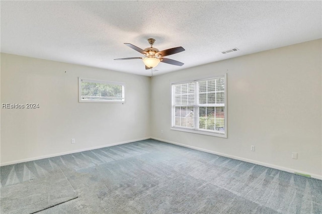 carpeted empty room with plenty of natural light and ceiling fan