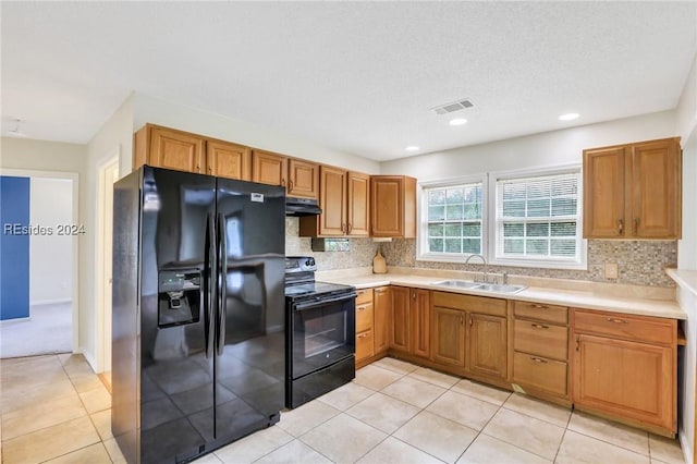 kitchen with sink, backsplash, black appliances, and light tile patterned floors