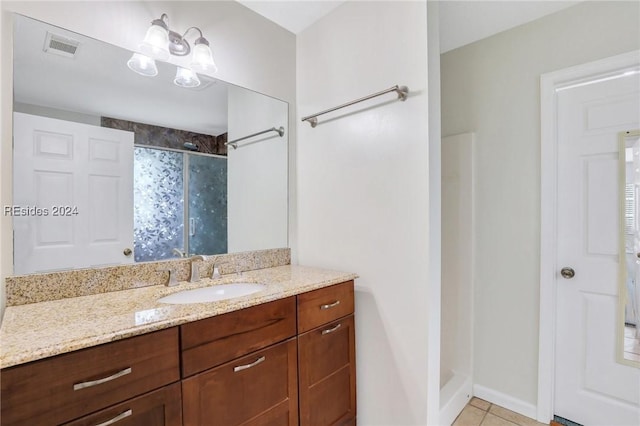 bathroom with vanity, curtained shower, and tile patterned floors