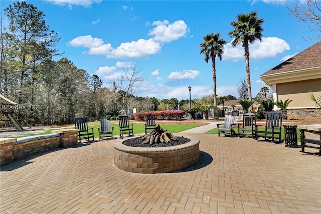 view of community featuring an outdoor fire pit