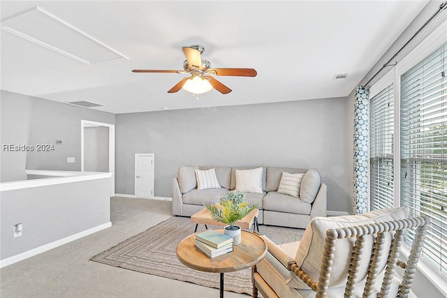 carpeted living room with ceiling fan and a healthy amount of sunlight