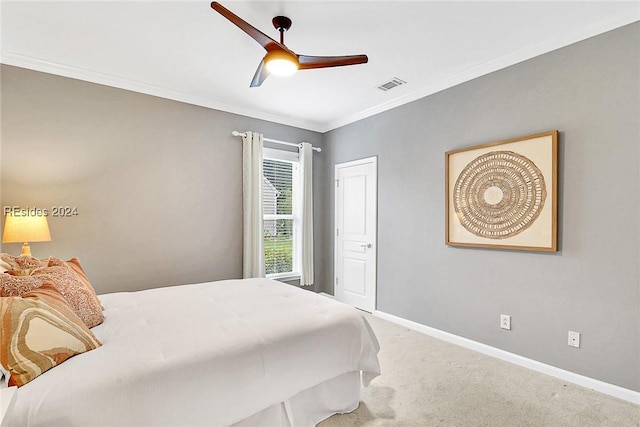 carpeted bedroom featuring crown molding and ceiling fan