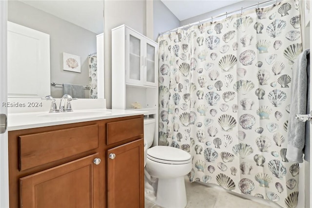 bathroom with vanity, tile patterned flooring, curtained shower, and toilet