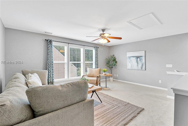 living room with ceiling fan and carpet