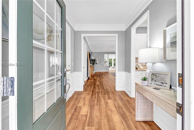 corridor featuring crown molding and light hardwood / wood-style floors