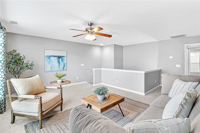 carpeted living room with ceiling fan