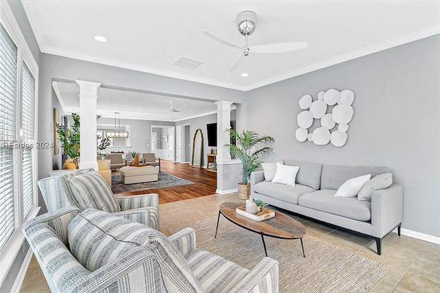 tiled living room with crown molding, ceiling fan, and decorative columns