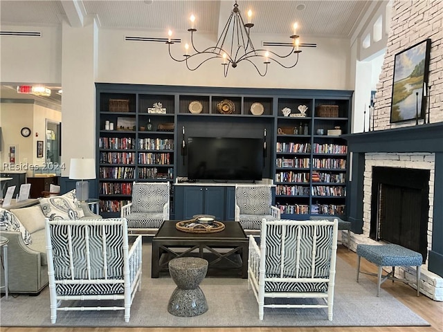 living room featuring a notable chandelier, hardwood / wood-style flooring, and a fireplace