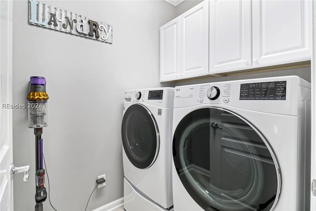 laundry room with cabinets and washing machine and dryer