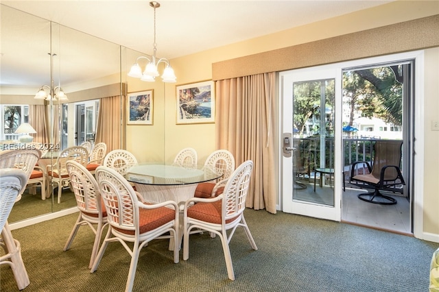 carpeted dining area featuring a notable chandelier