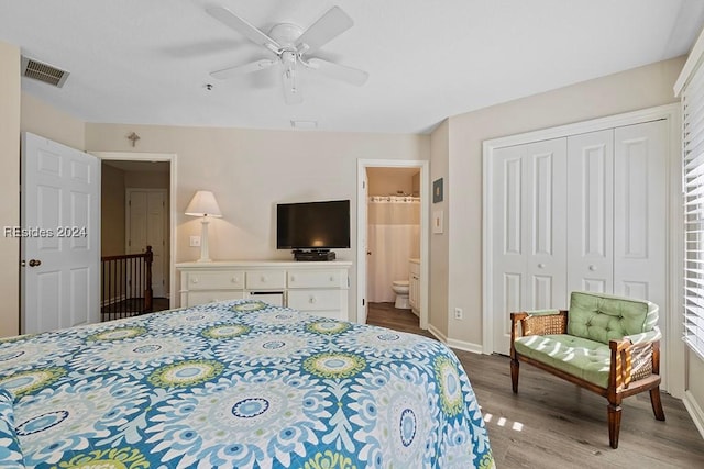 bedroom with ensuite bath, light hardwood / wood-style flooring, ceiling fan, and a closet