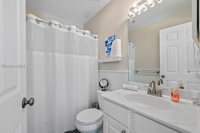 bathroom featuring vanity, vaulted ceiling, and toilet