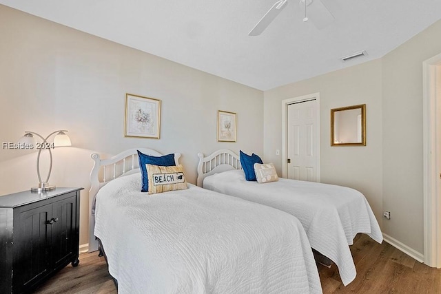 bedroom with dark hardwood / wood-style floors and ceiling fan