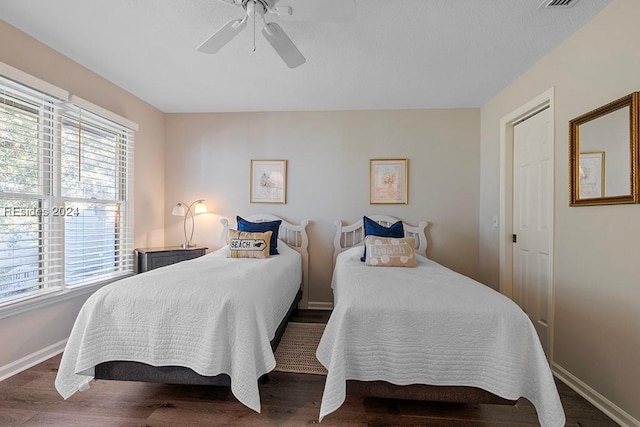 bedroom featuring dark wood-type flooring and ceiling fan