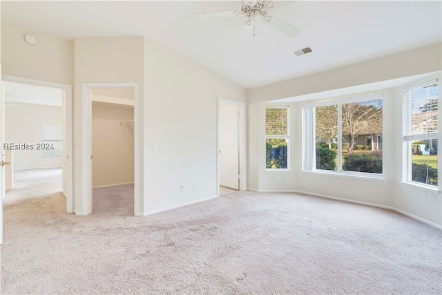 carpeted spare room with lofted ceiling and ceiling fan