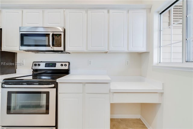 kitchen featuring white cabinetry, light tile patterned floors, and stainless steel appliances