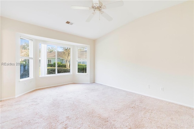 carpeted empty room featuring vaulted ceiling and ceiling fan