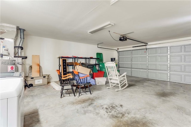 garage with a garage door opener and washer / dryer