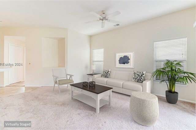 living room featuring light colored carpet and ceiling fan