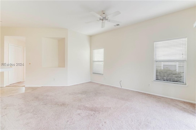 carpeted spare room featuring ceiling fan