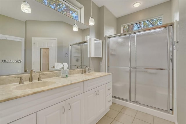 bathroom with an enclosed shower, vanity, plenty of natural light, and tile patterned floors