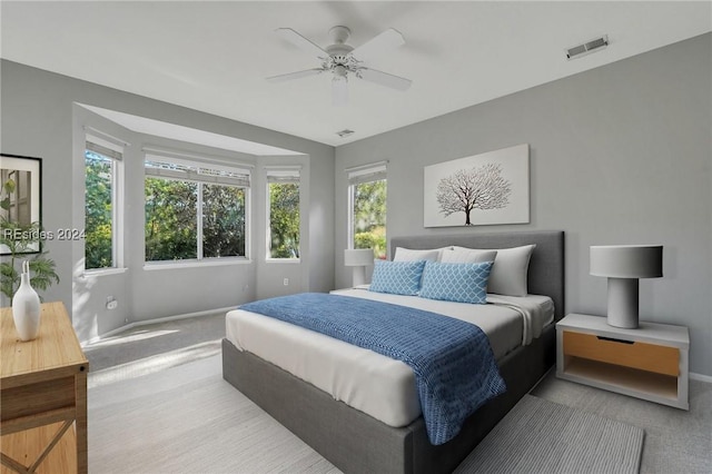 bedroom featuring light carpet and ceiling fan